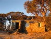 The hut glows in the bright light of sunrise.